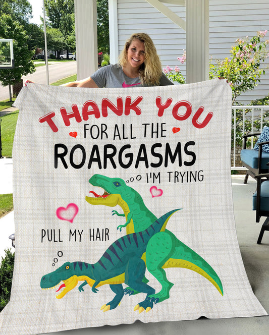 Woman holding a T Rex Blanket outside