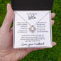 Hand holding a to my wife love knot necklace